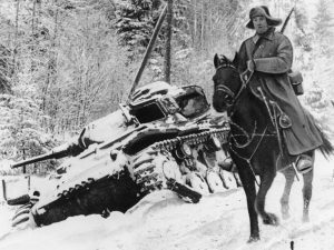 A horseback rider of the Red Army cavalry, clad in heavy winter gear, is seen as he passes a German tank abandoned by the retreating German invaders, at an unknown location along the German-Russian front, on February 22, 1942. (AP Photo)