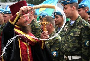 An Orthodox priest blesses Russian paratroopers during celebration of their forces' annual holiday at the Red Square in Moscow on August 2, 2009. TOPSHOTS/AFP PHOTO/ANDREI SMIRNOV (Photo credit should read ANDREI SMIRNOV/AFP/Getty Images)